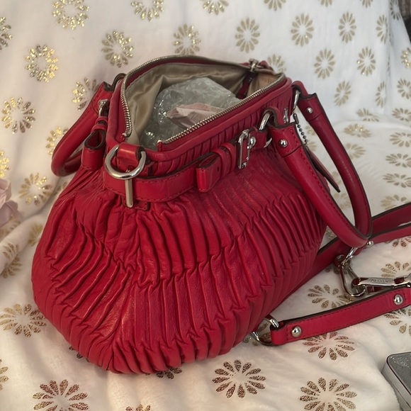 It’s called Burgundy, but looks like red. Rouched leather with silver hardware. - Picture 2 of 3